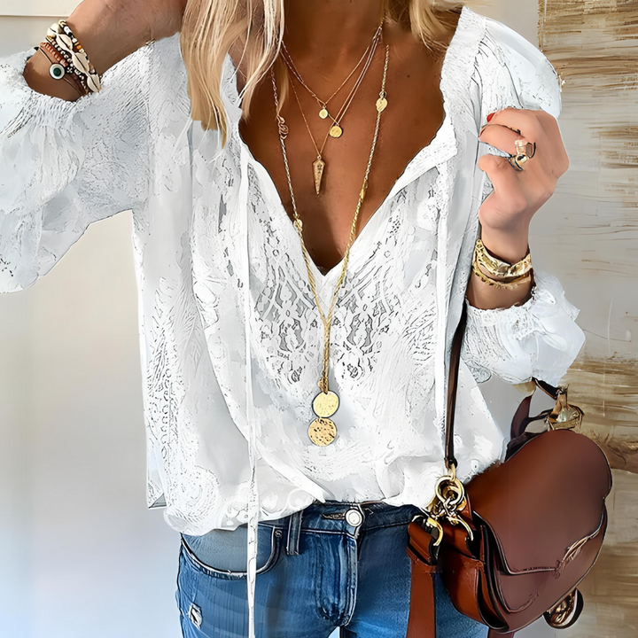 White women's flowy bohemian blouse with a stylish split neck. A fashionable vintage top for spring/summer.