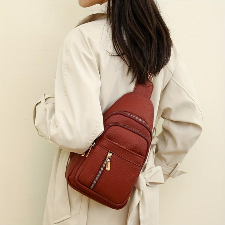 Durable leather vintage style chest crossbody for women, secure storage.