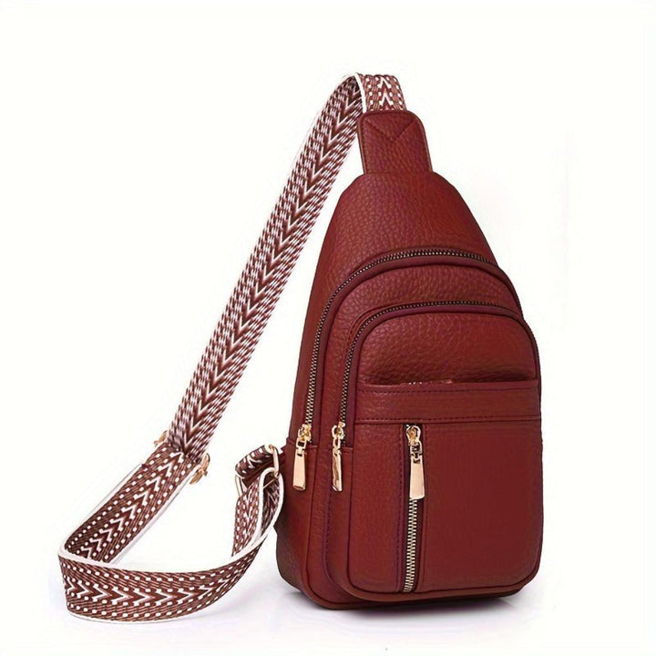 Black vintage leather chest crossbody bag with an organized interior.