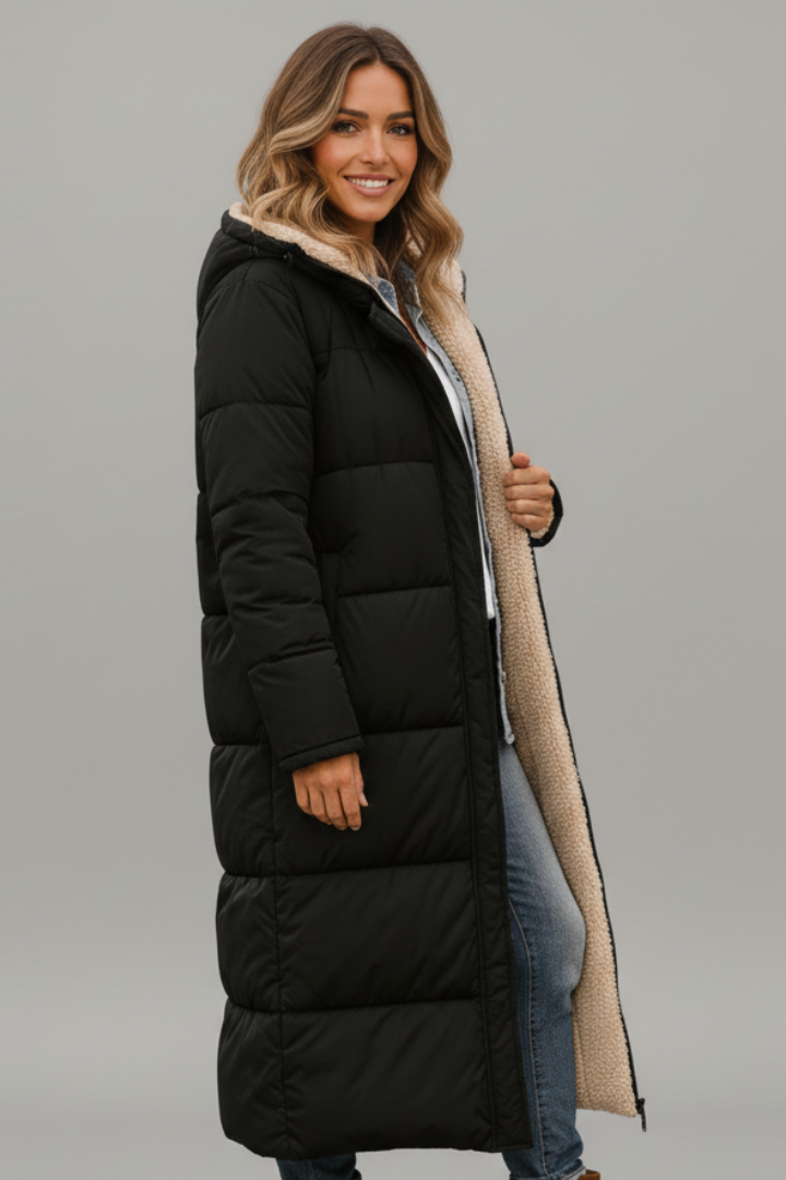 Full-zip women's long quilted winter coat with hood, providing warmth & protection against cold weather.