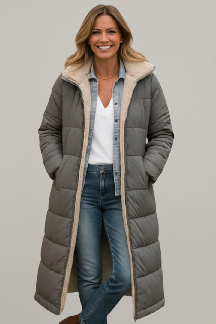 Warm women's long quilted coat featuring a hood, full-zip, and side pockets, ideal winter outerwear.