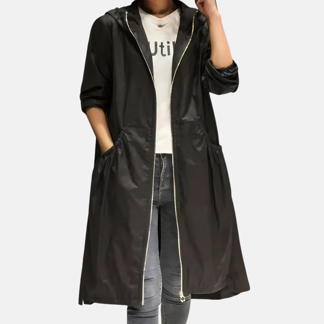 Lightweight women's water-resistant rain jacket with hood. Knee-length design for spring & fall protection and fashion.
