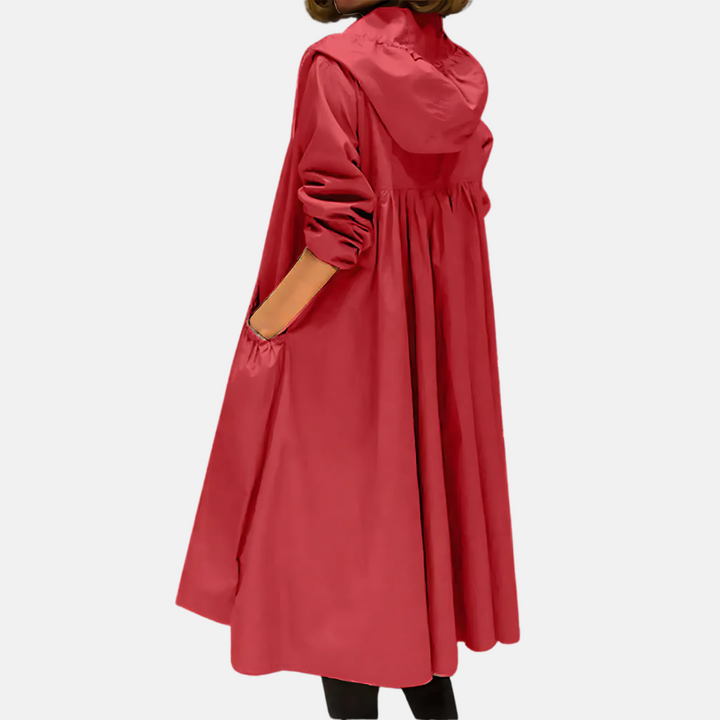 Full view: women's water-resistant hooded rain jacket. Knee-length for ultimate coverage, ideal for travel.