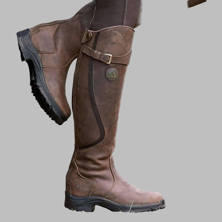 Women's waterproof equestrian riding boots with secure grip sole, tall design, and all-weather performance.