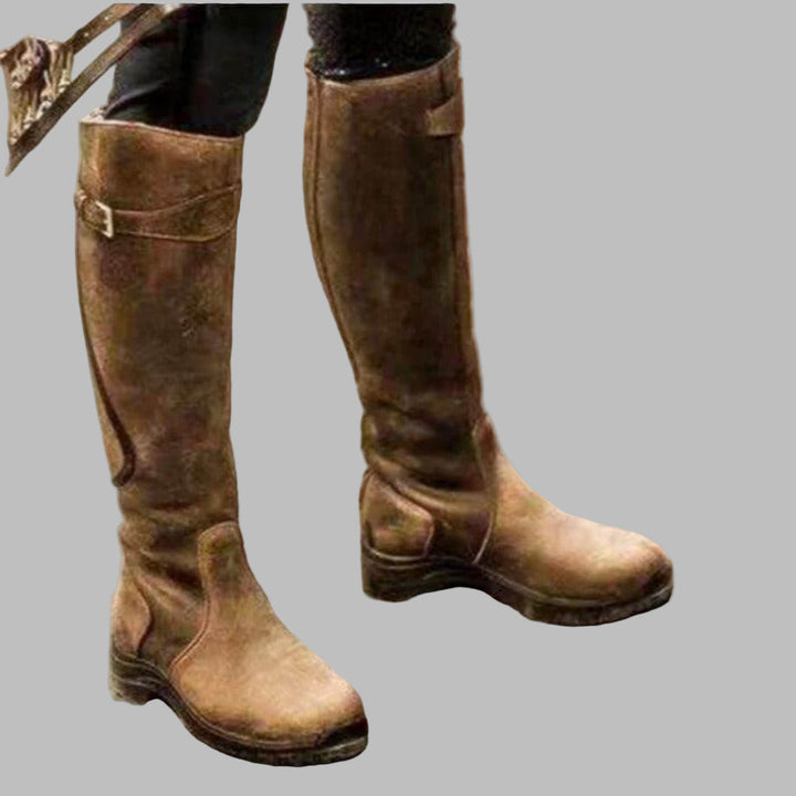 Performance women's outdoor riding boots, waterproof & durable, featuring a secure grip sole for all-weather equestrian use.