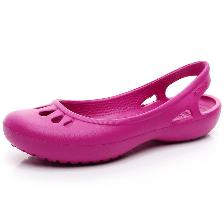 Casual women's waterproof flat slide sandals with intricate cut-out design, ideal for beach & pool.