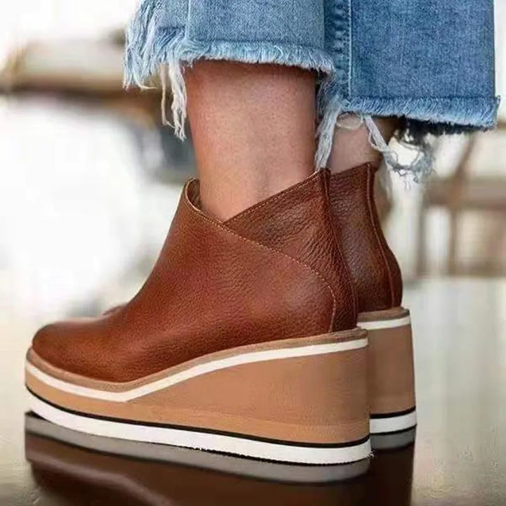 Weather-resistant women's boots with orthopedic support, featuring an easy side zipper for casual style.
