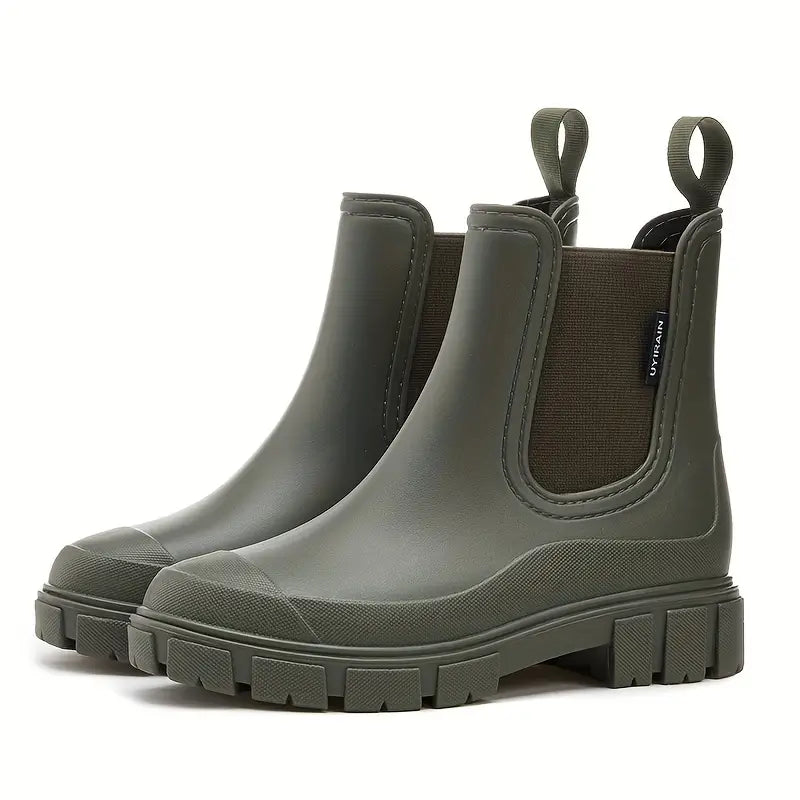Woman walking in puddles wearing black waterproof slip-on Chelsea boots, durable rain footwear