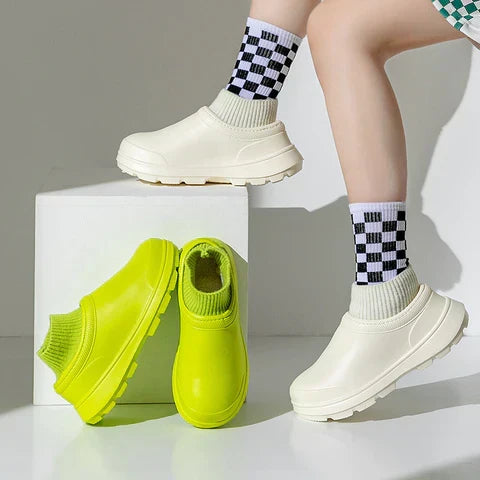 Front view of women's waterproof slip-on clogs, showcasing the comfortable knit ankle cuff.