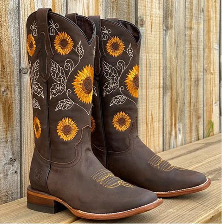 Mid-calf women's embroidered cowboy boots with unique sunflower pattern and classic pointed toe. Western appeal.