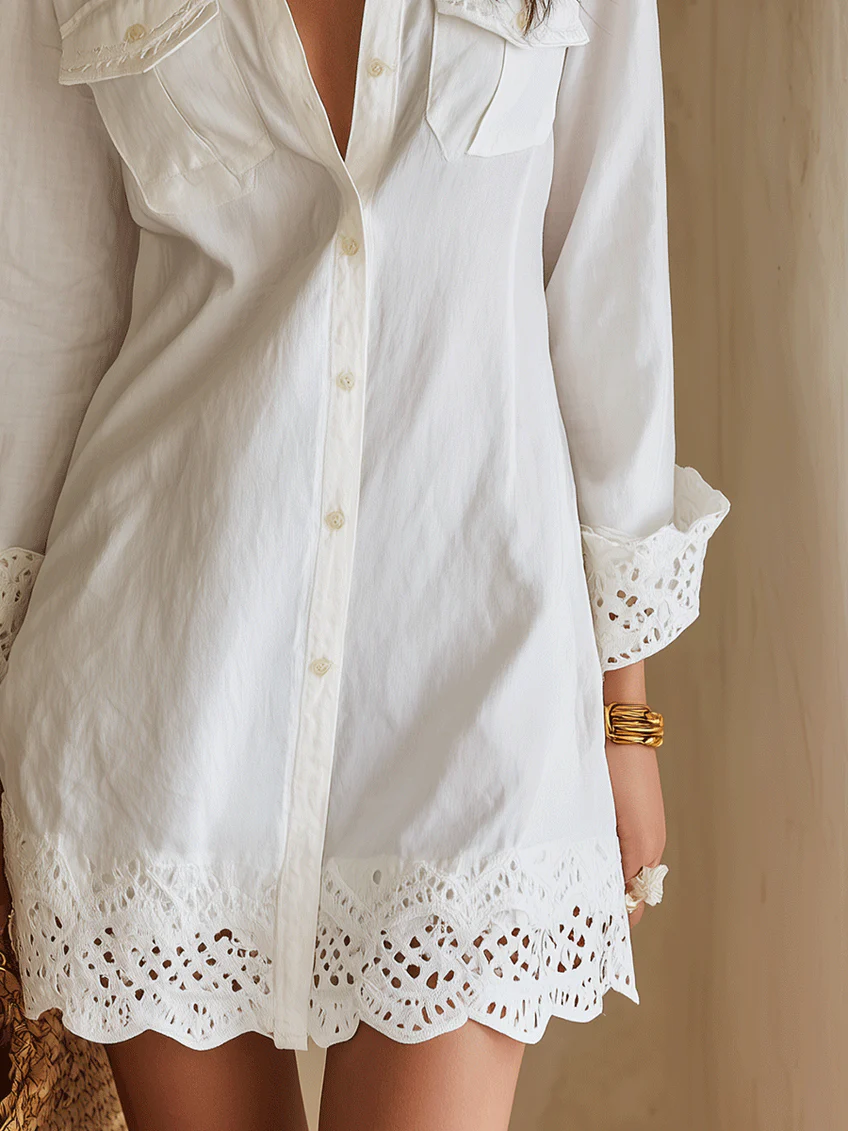 Boho chic women's white long-sleeve collared shirt dress, mini length, featuring a beautiful crochet hem. Vacation ready.