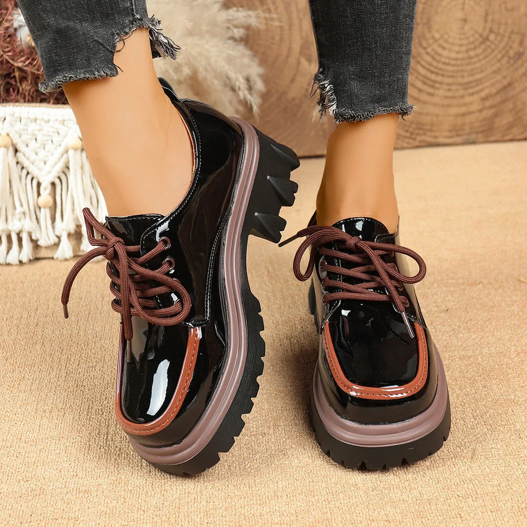 Side view of women's leather-look platform sneakers, showcasing the elevated lug sole & laces