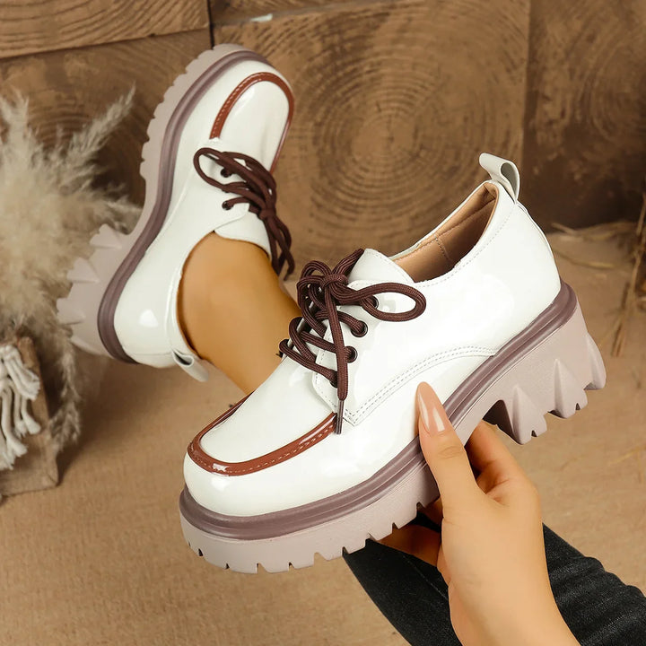 Detailed shot of women's white platform sneaker sole, highlighting the durable, shock-absorbing lug pattern