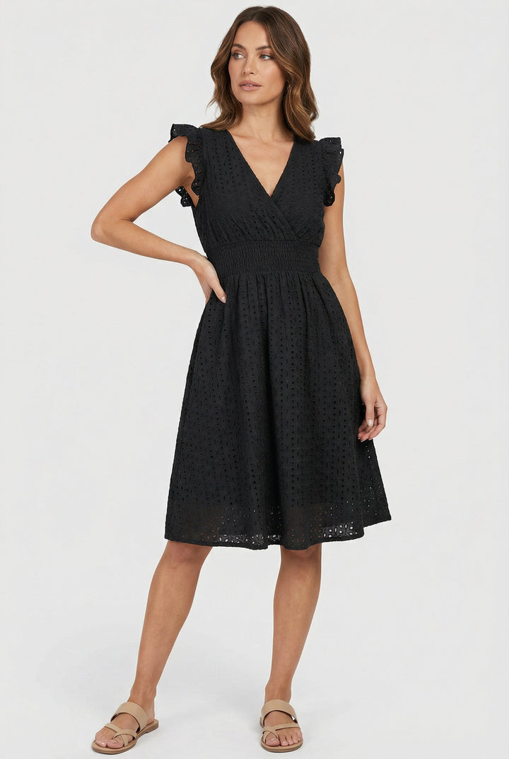 Effortless women's beach midi dress, eyelet detail, smocked waist, and ruffled cap sleeves.