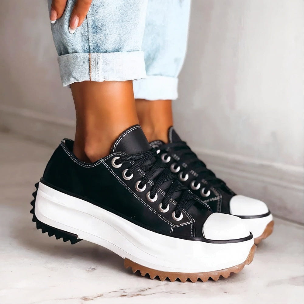 Women's white lace-up low-top platform sneakers. Casual, trendy fashion footwear with an elevated sole.