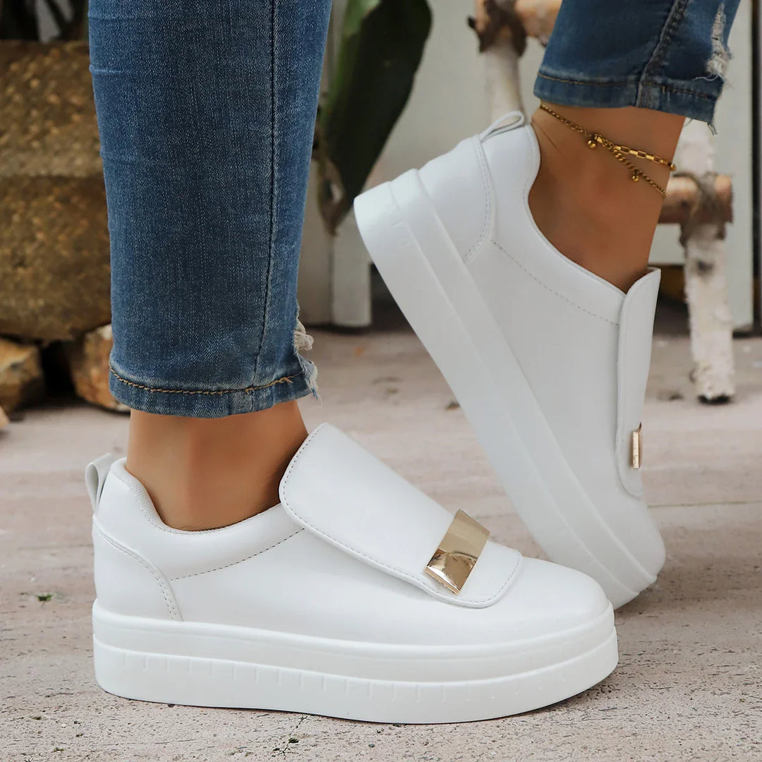 Pair of women's fashion platform sneakers with gold detailing and orthopedic support.