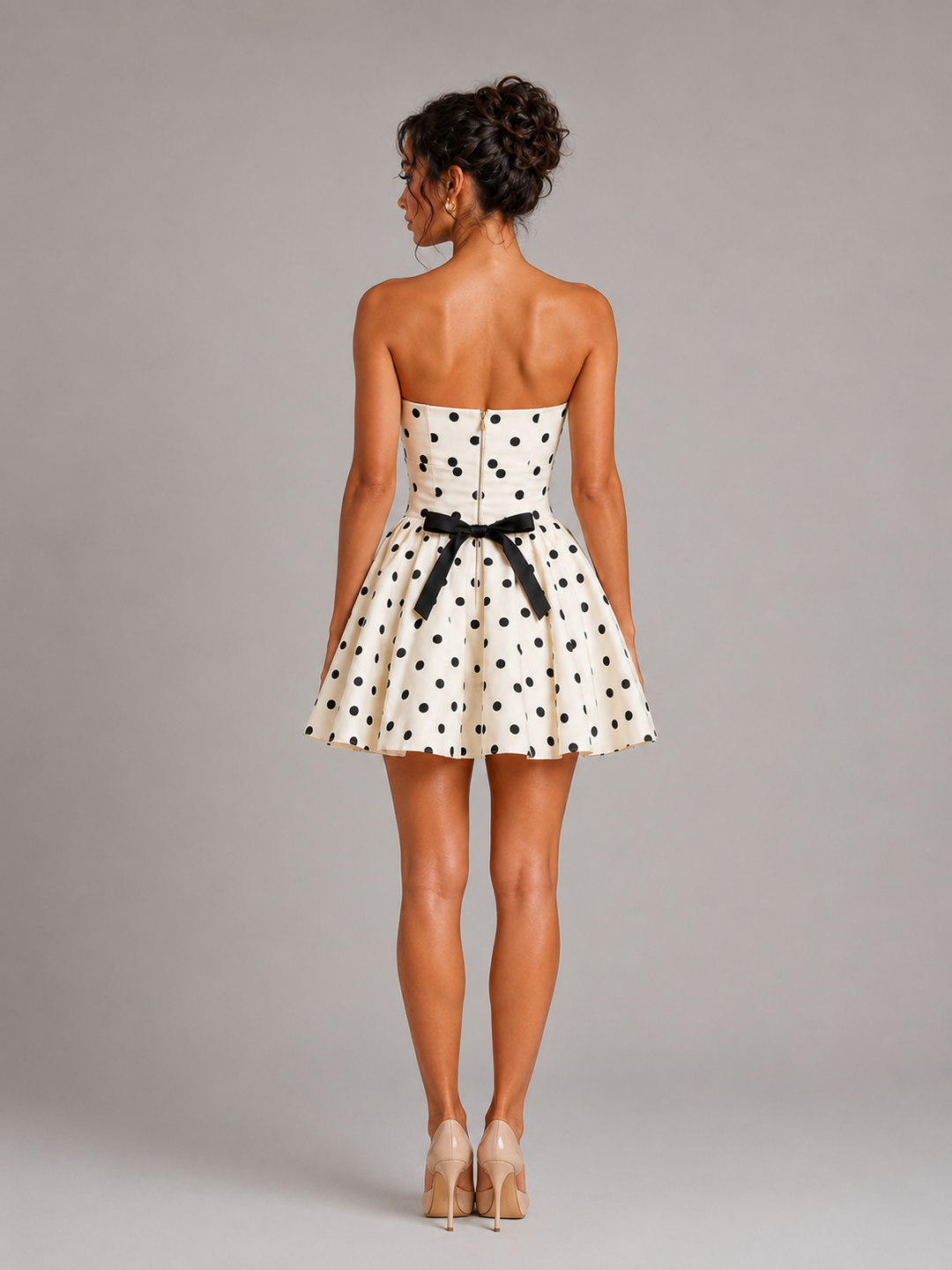 Chic strapless white polka dot mini dress for homecoming or parties. Features a retro-inspired skater silhouette.