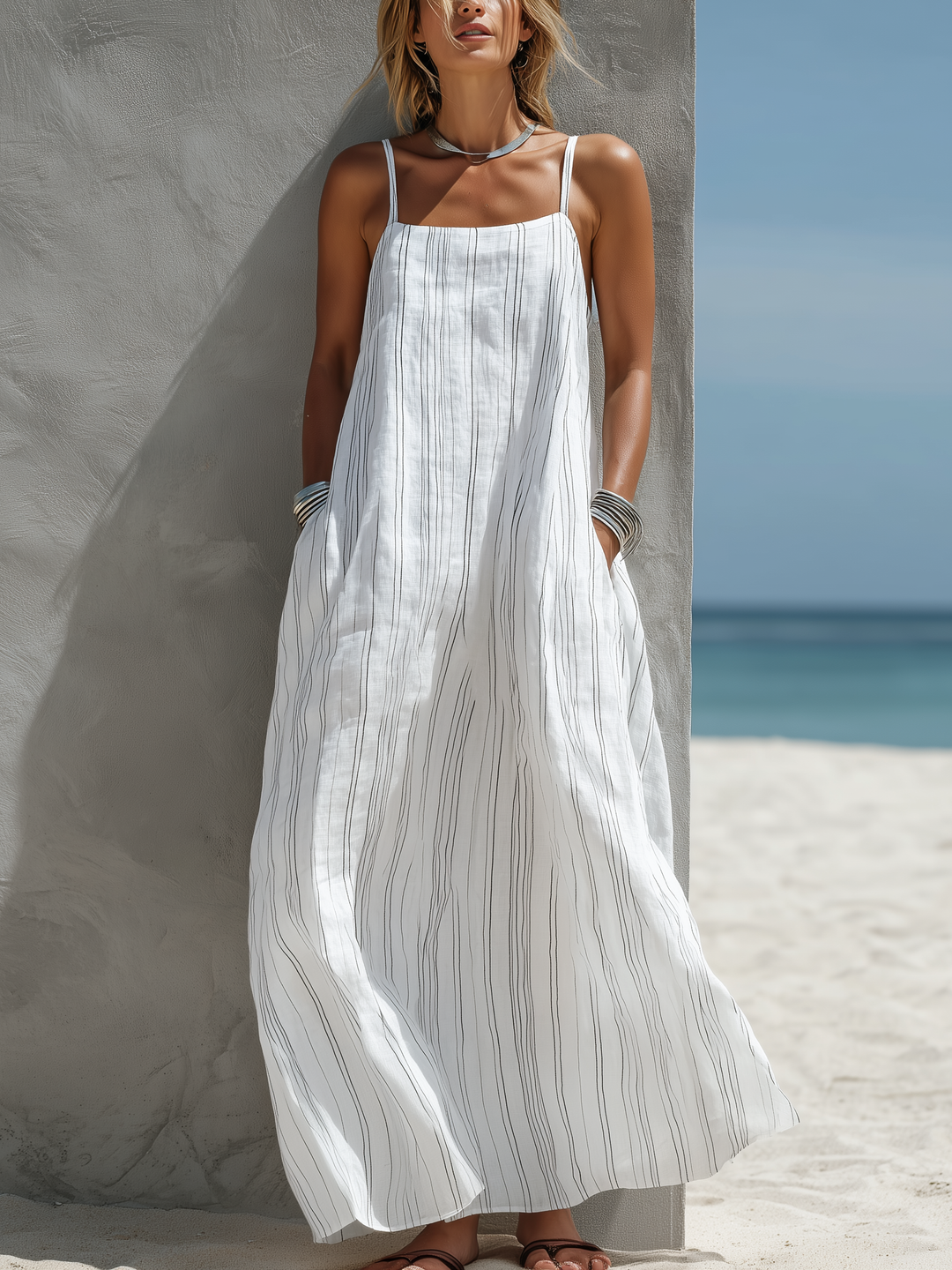 Women's white striped square neck maxi dress with spaghetti straps, perfect for beach or summer vacation.