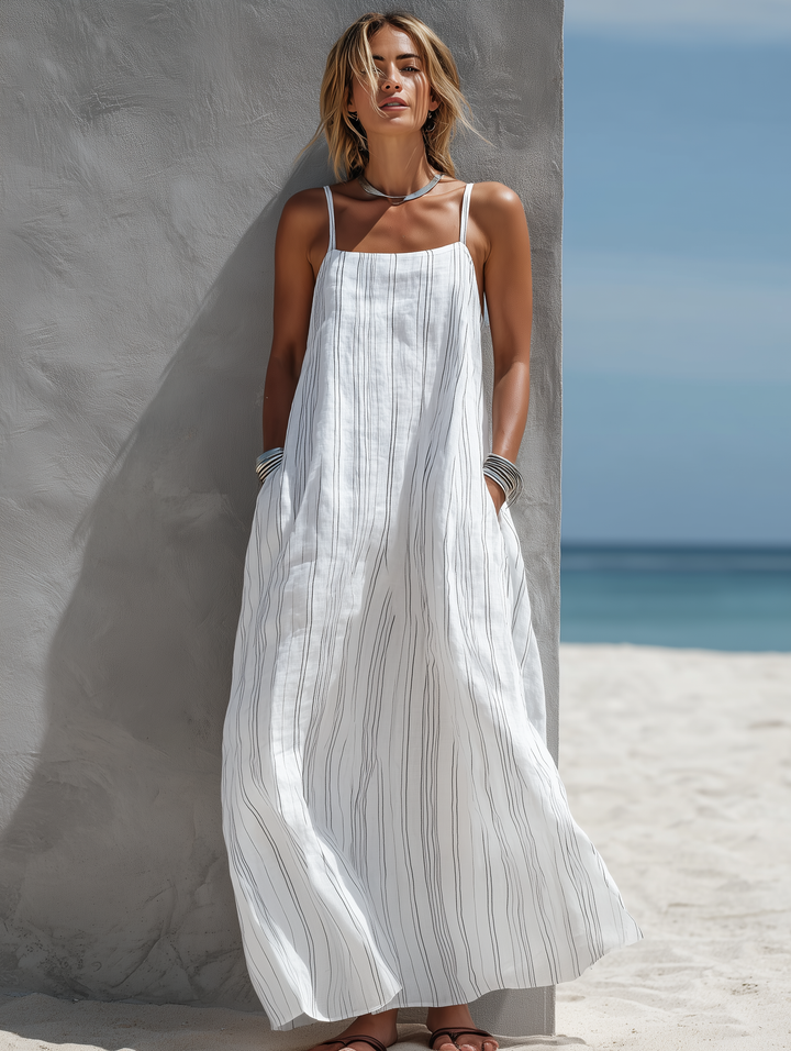 Stylish women's white striped maxi dress with square neck and spaghetti straps, ideal for summer beach days.