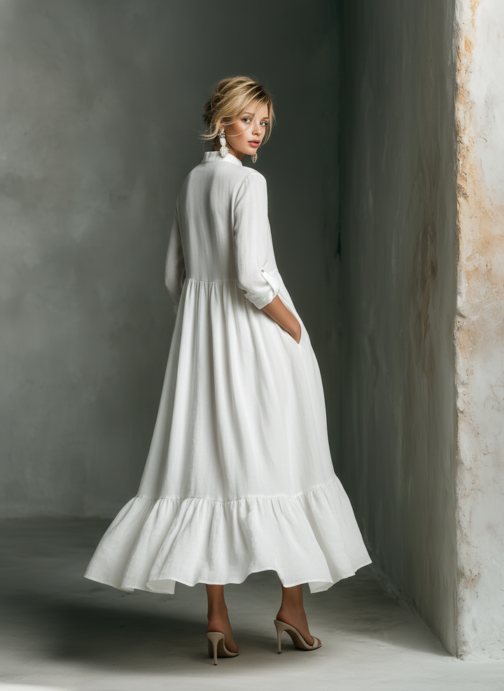 Stylish women's white tiered maxi dress, featuring a flattering stand collar, long sleeves, and a relaxed fit.