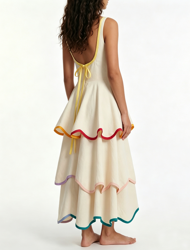 Boho white tiered maxi dress for women, featuring a bright rainbow trim. Comfortable summer fashion & festival wear.