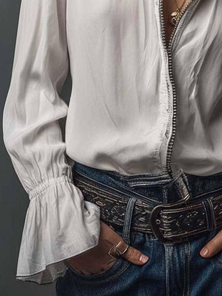 Crisp white women's blouse with a practical zip-front and chic bell cuffs. A versatile long-sleeve top.