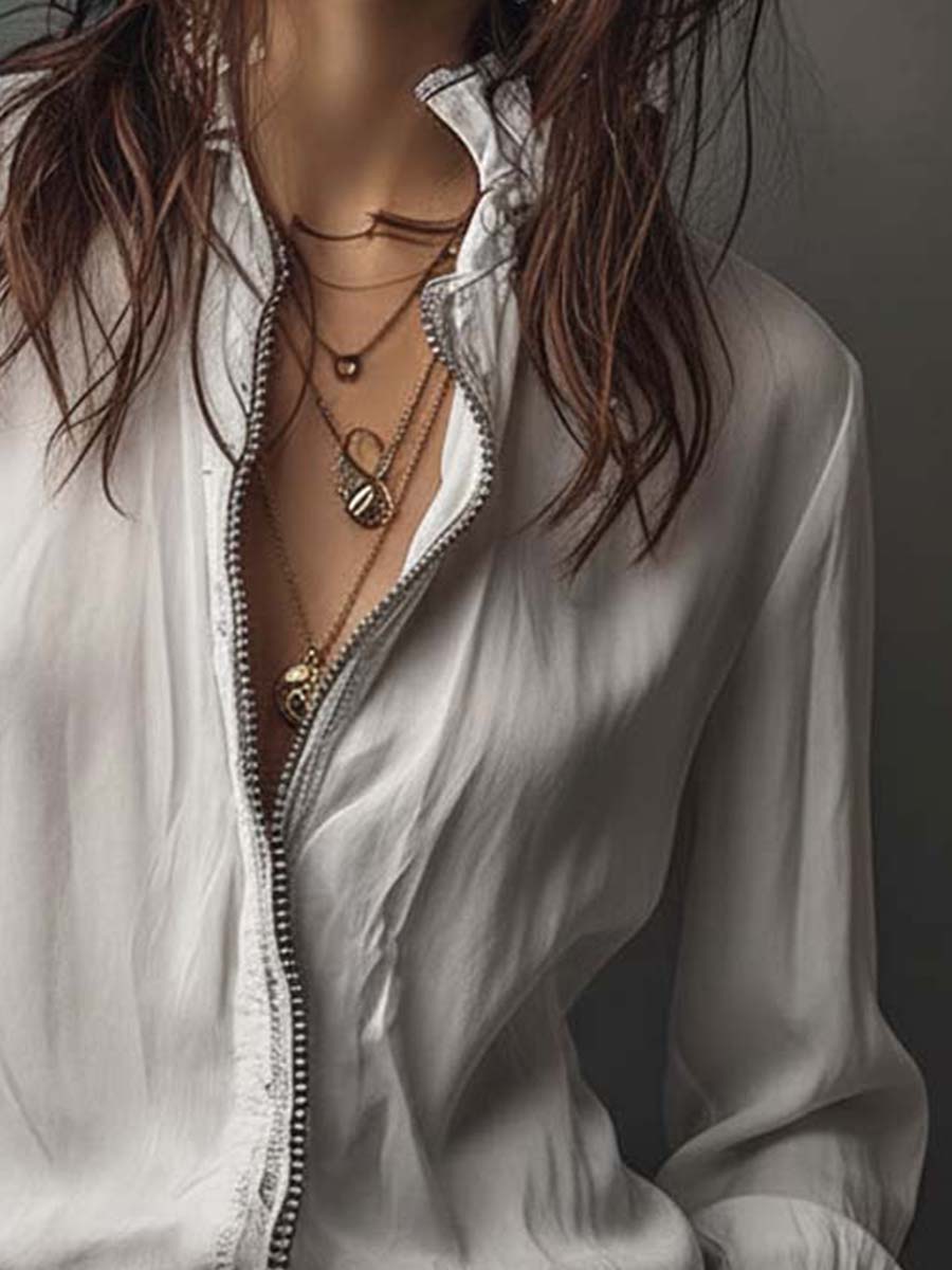Chic white zip-front women's blouse featuring stylish bell cuffs. A versatile long-sleeve top for modern women.