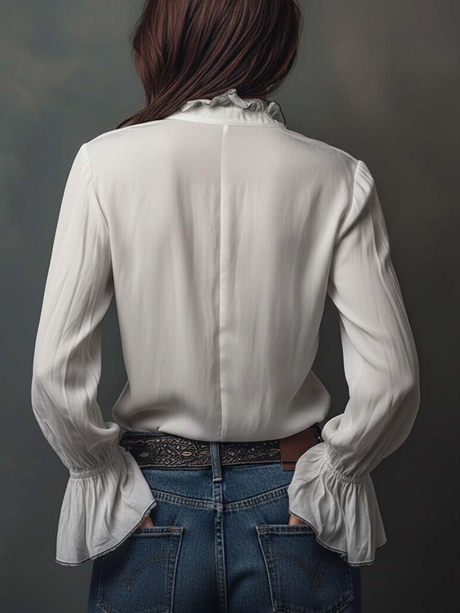 Professional white women's blouse with a sophisticated zip-front and elegant bell cuffs. Tailored office wear.