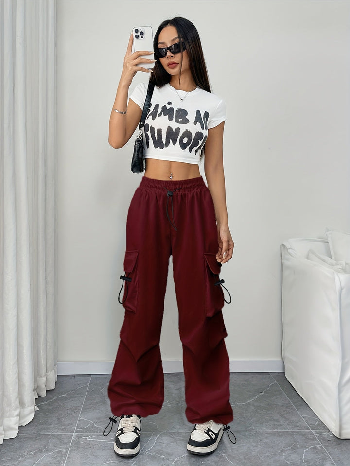 Stylish women's wide leg cargo pants, drawstring waist, multiple utility pockets. Perfect for streetwear.