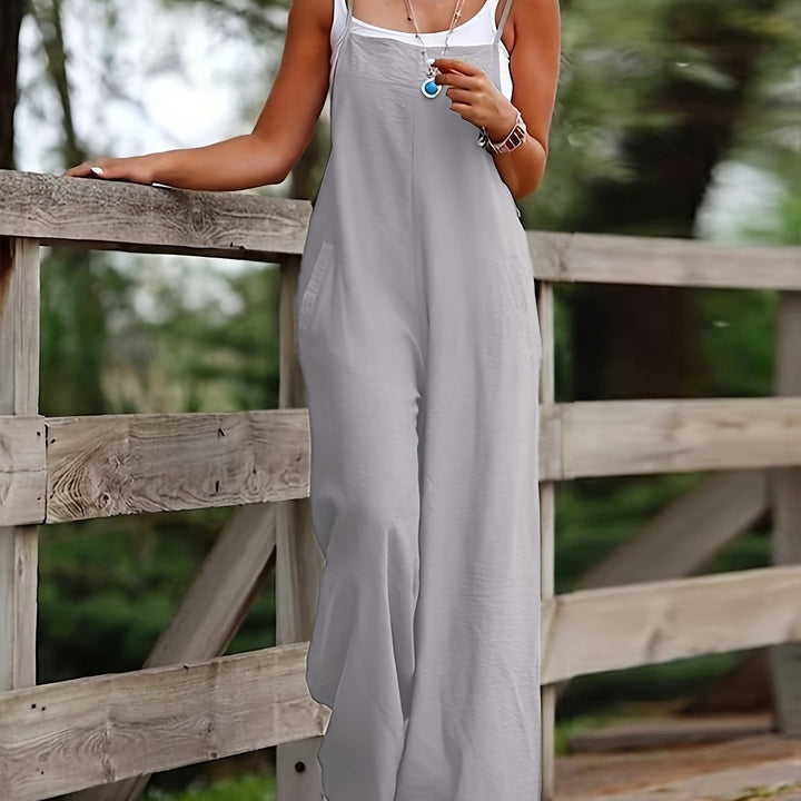 Vacation-ready women's wide leg sleeveless dungaree jumpsuit, with ample pockets.