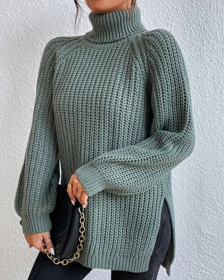 Full length shot of a woman in jeans and a white ribbed long sleeve turtleneck sweater