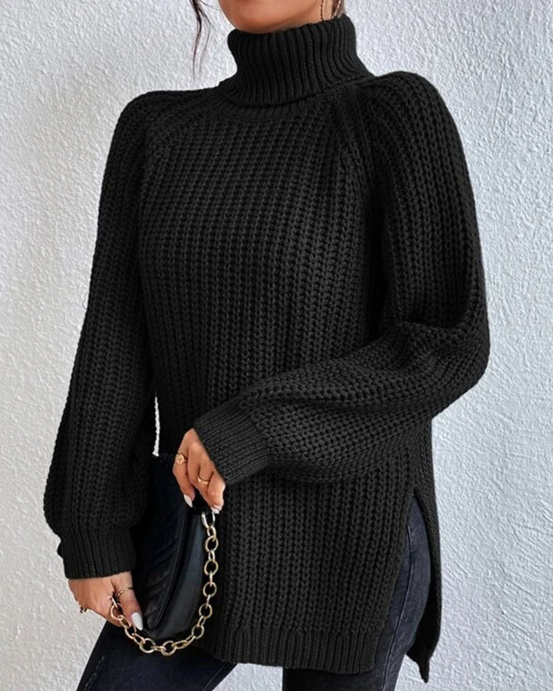 Detail of the high, folded turtleneck collar on a women's cozy knit sweater