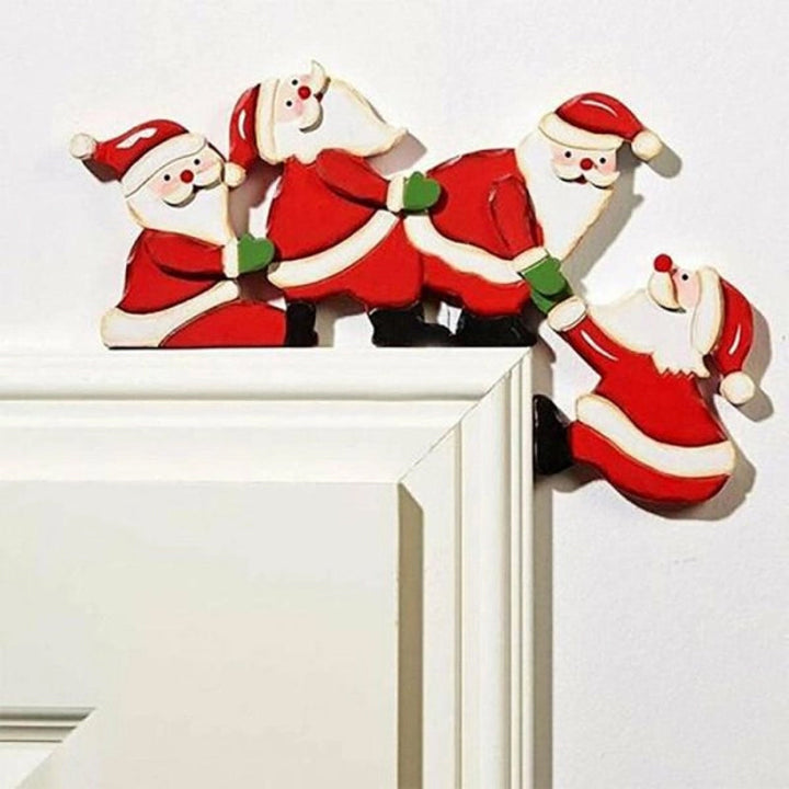 Wooden door frame decor with Santa Claus and an elk, creating a festive Christmas entrance.