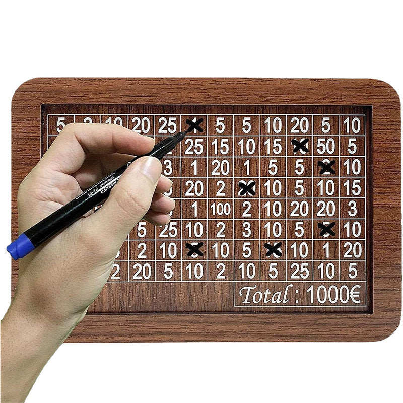 Hand placing coins into a stylish wooden money box with a visible savings tracker
