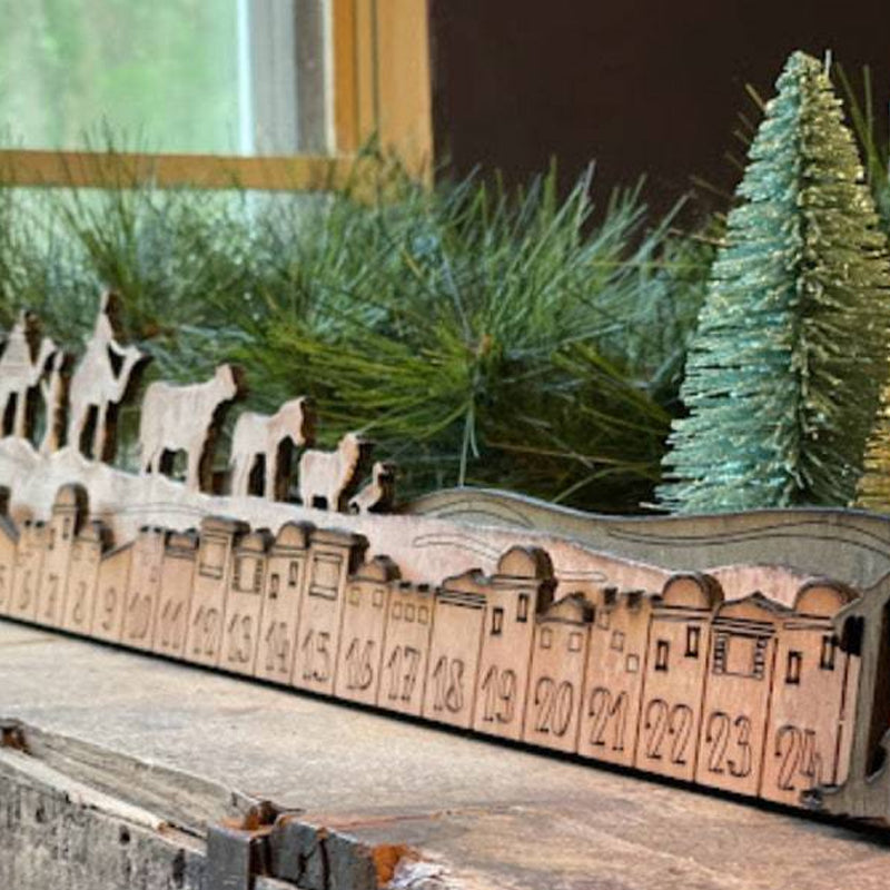 Detailed view of a single door on the wooden Nativity Christmas Advent Calendar, numbered and festive