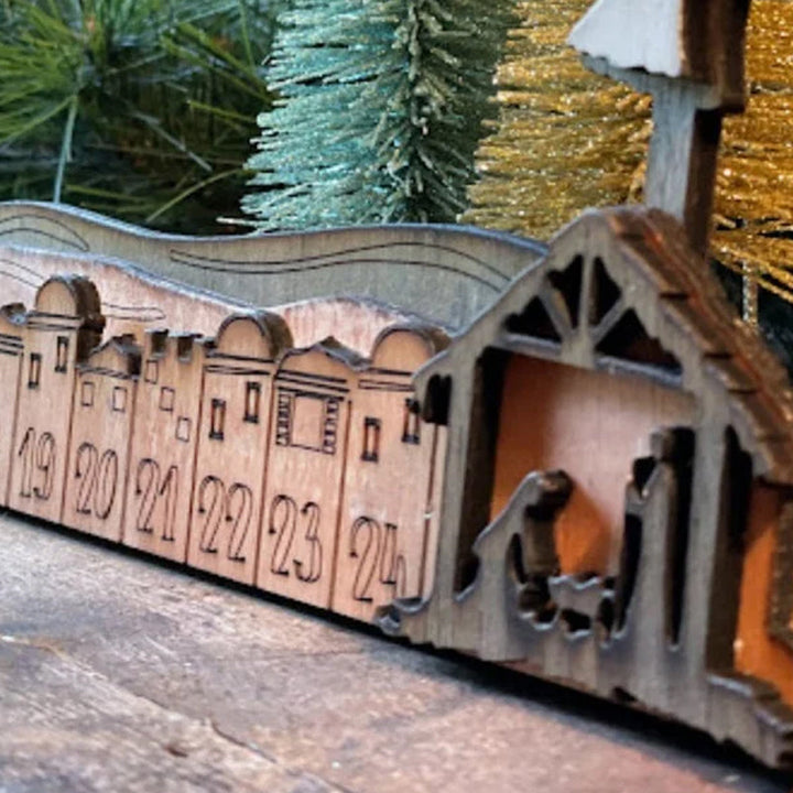 Wooden Nativity scene at the base of an Advent Calendar, depicting the birth of Christ for Christmas