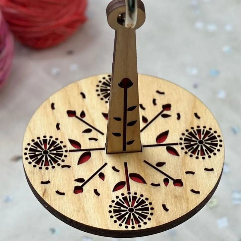 Smooth rotating wooden yarn spindle for effortless and tangle-free crafting sessions.