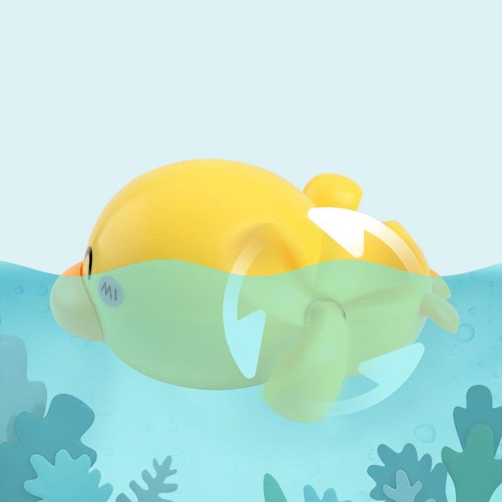 Collection of colorful wind-up duck bath toys swimming in water, great for group play