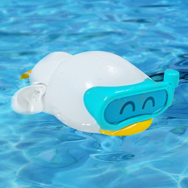 Single yellow wind-up swimming duck bath toy floating on calm blue water, a fun kids' toy