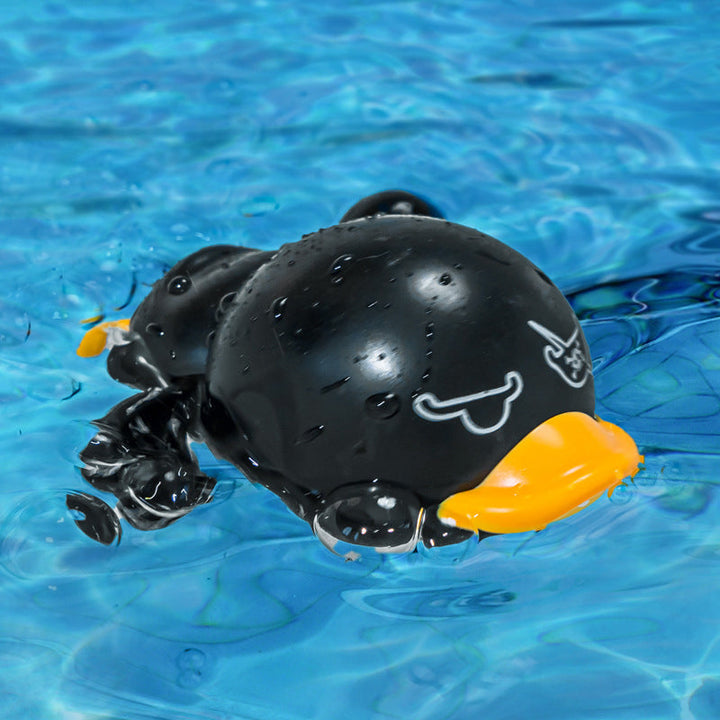 Wind-up duck bath toy with water splashing around it, creating exciting water play for babies