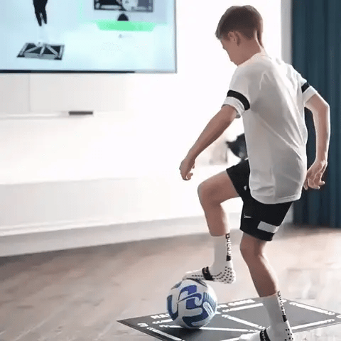 Indoor football training mat for youth, designed with a grippy surface for safe skill drills & home practice.